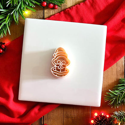 Polymer clay oyster gift cutter on white tile with Christmas greenery
