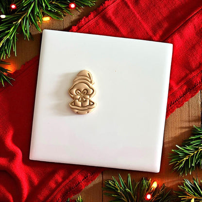 Polymer clay oyster present design shown on white tile with red background