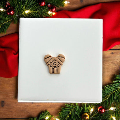 Gingerbread mouse house clay impression centered on white tile with red background
