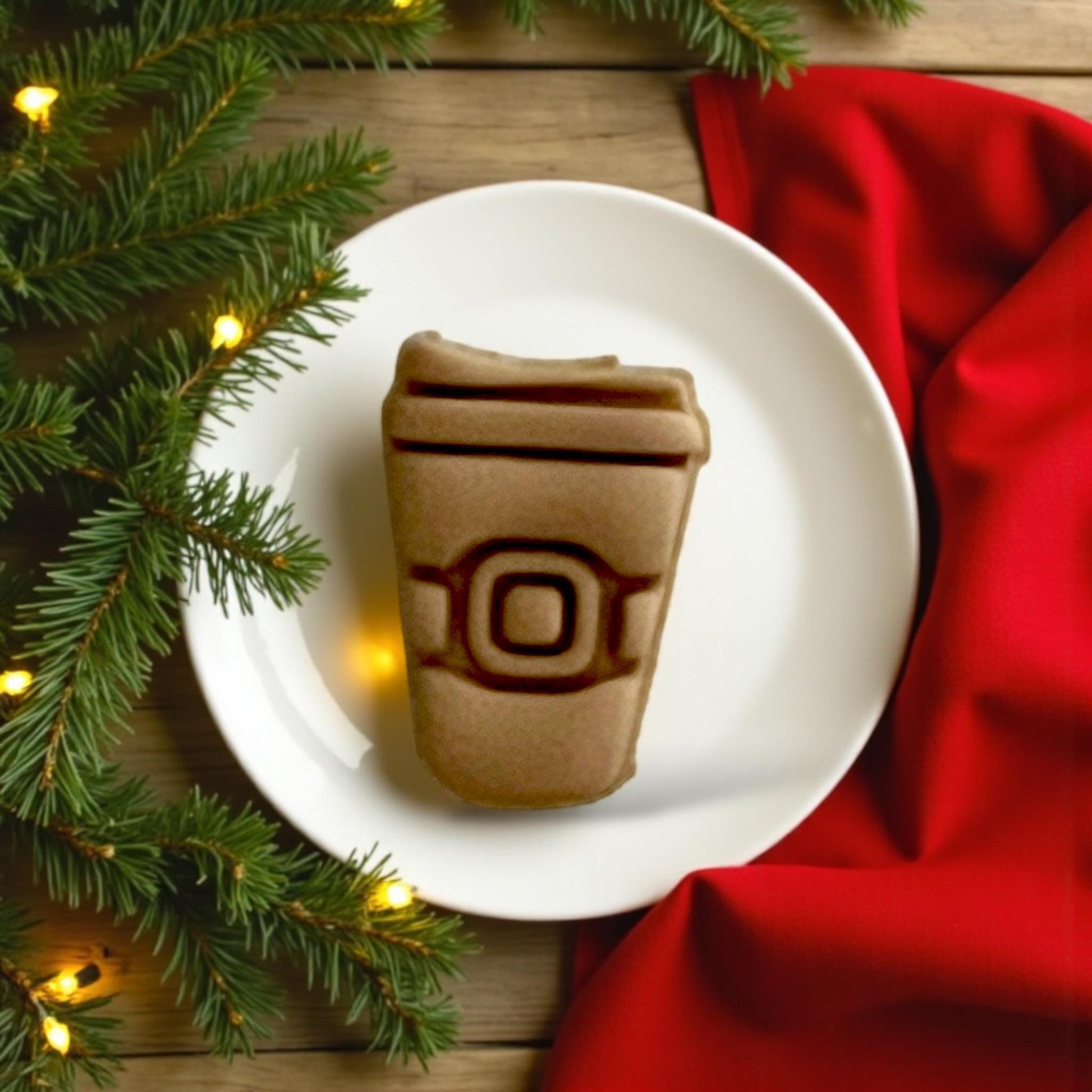 Large Santa coffee cup clay impression on white plate with red fabric and pine branches