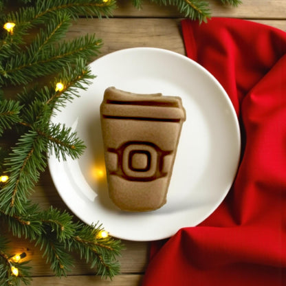 Large Santa coffee cup clay impression on white plate with red fabric and pine branches