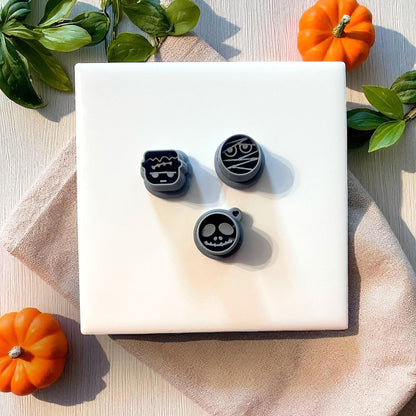 Three Halloween polymer clay cutters with skull, mummy, and Frankenstein designs