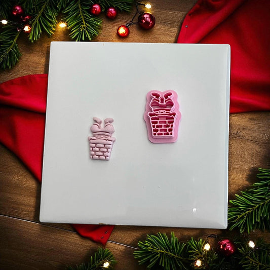 Pink Santa chimney clay imprint and cutter side by side on white tile