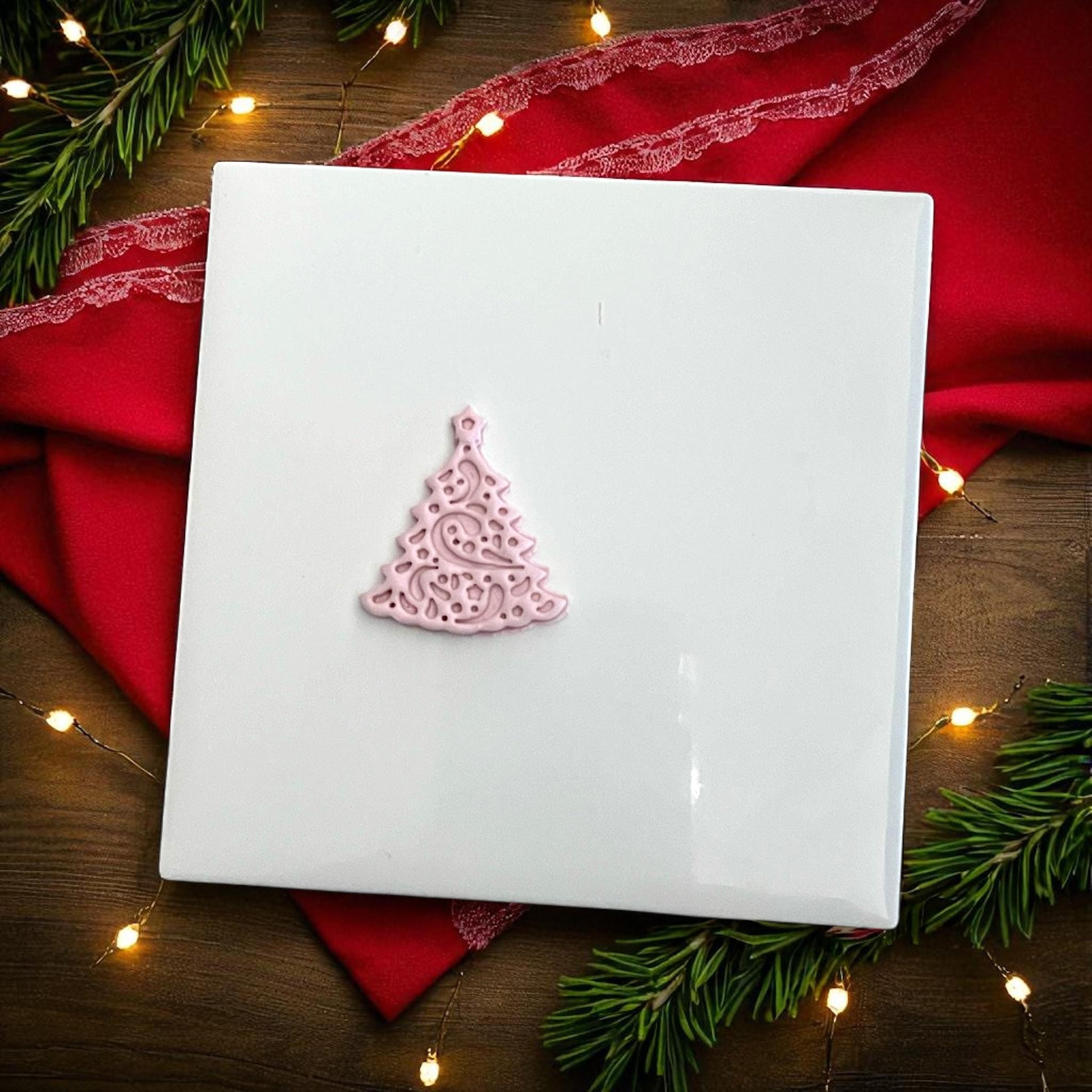 Small pink Christmas tree clay imprint with holiday lights and greenery