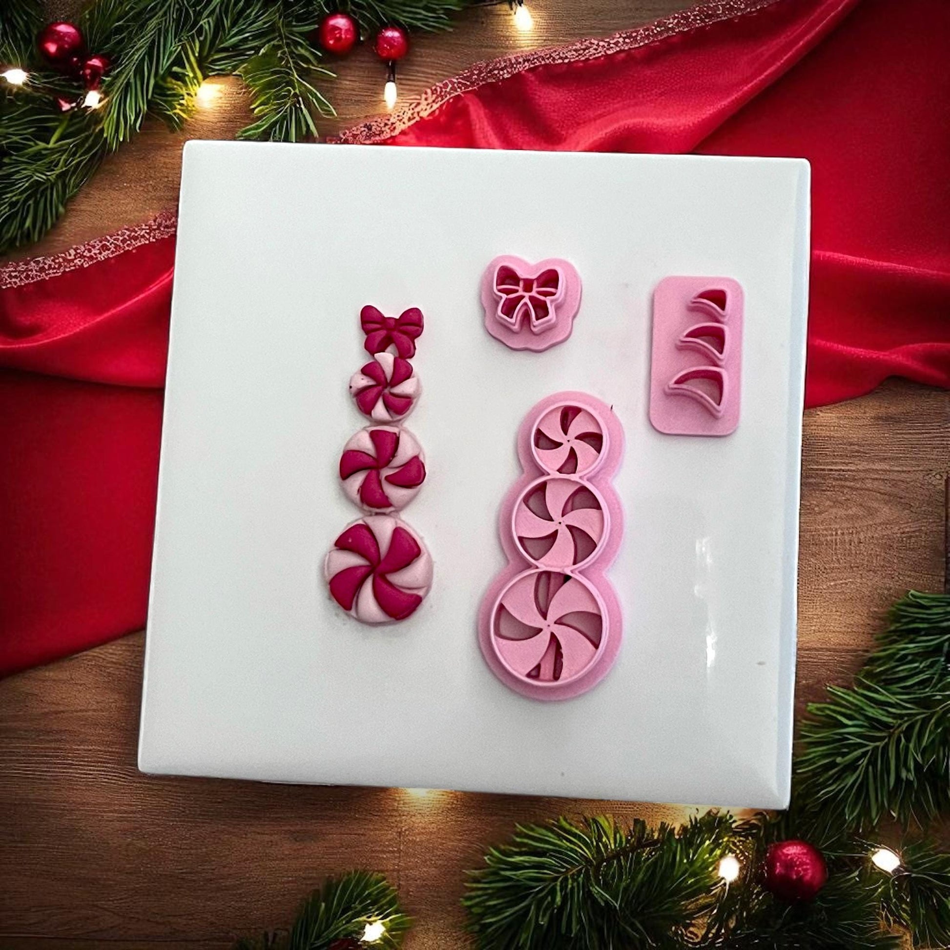 Peppermint candy snowman clay pieces with matching cutters on white tile