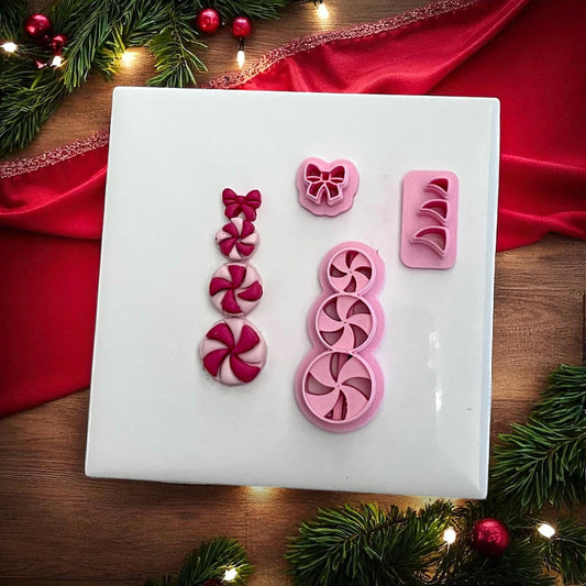 Peppermint candy snowman clay pieces with matching cutters on white tile