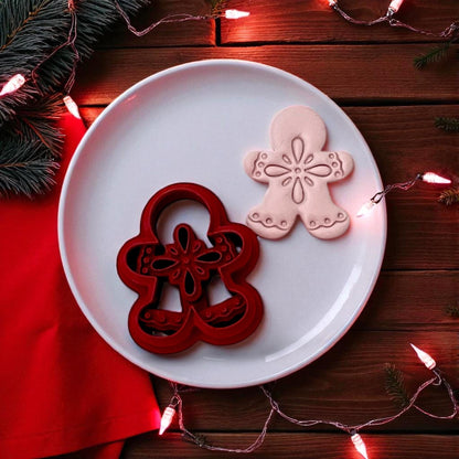 Boho gingerbread man clay cutter and clay shape side by side on white plate