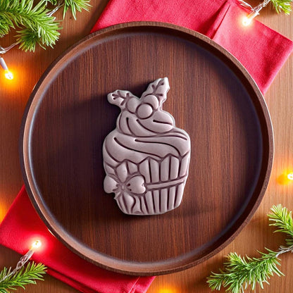 Large Christmas cupcake clay piece on wooden plate with red napkin