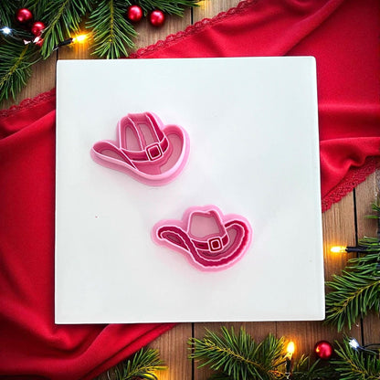 Christmas cowboy hat clay impressions in red and pink on white tile with lights