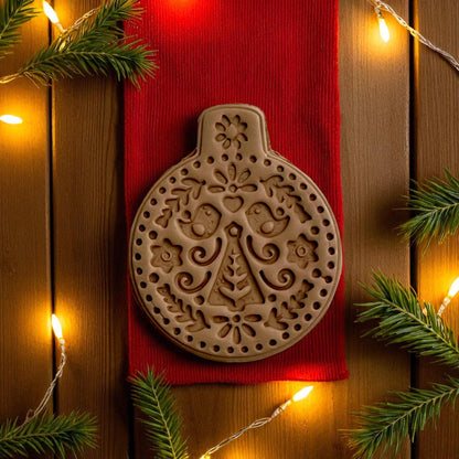 Close-up of Scandinavian tree ornament clay imprint with lights and pine branches