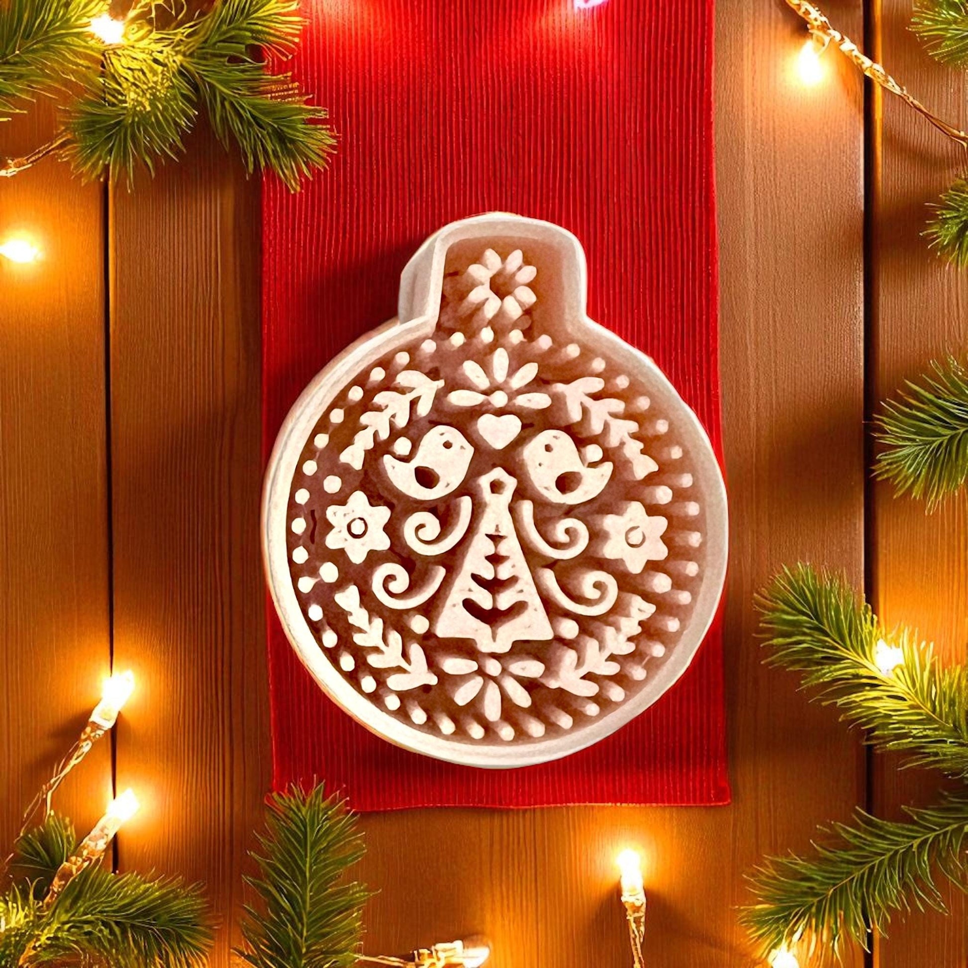 Scandinavian ornament cutter close-up showing folk birds and floral tree pattern