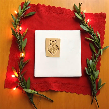 Grinch ornament polymer clay imprint with bow and candy cane on tan clay