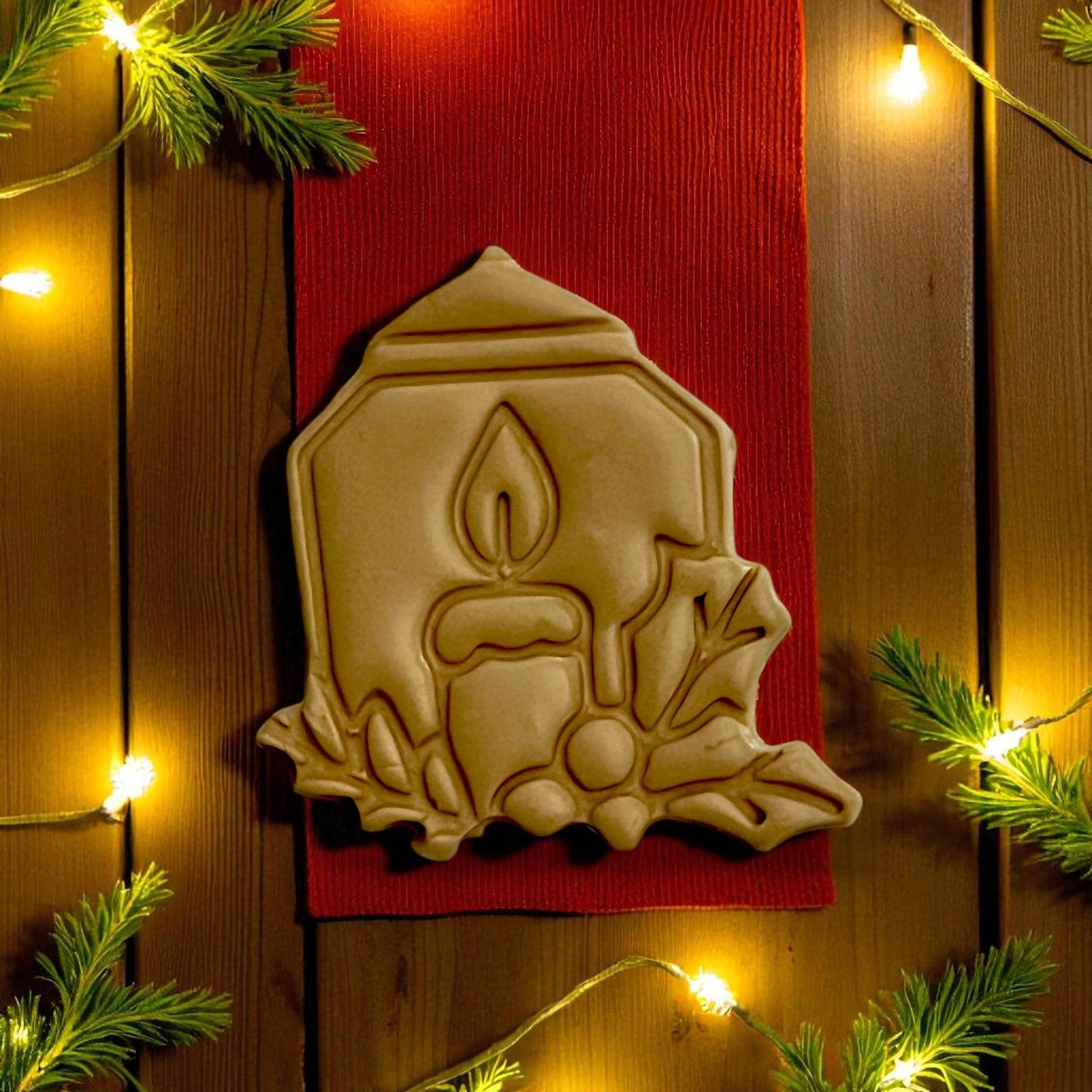 Candle polymer clay imprint on tan clay with red fabric and pine greenery