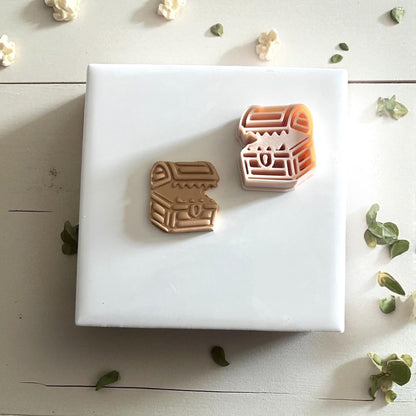 Clay impression of mimic chest on white plate with beige fabric and green leaves