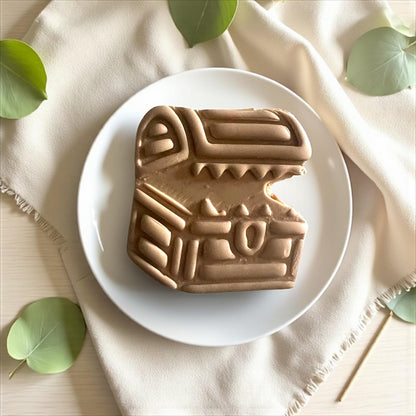 Two mimic chest clay cutters on white tile surrounded by plant pieces