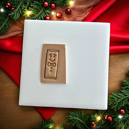 Gingerbread bar polymer clay cutter displayed on white tile with Christmas decor