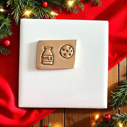 Close-up of milk and cookie clay shapes on a plate with holiday lights
