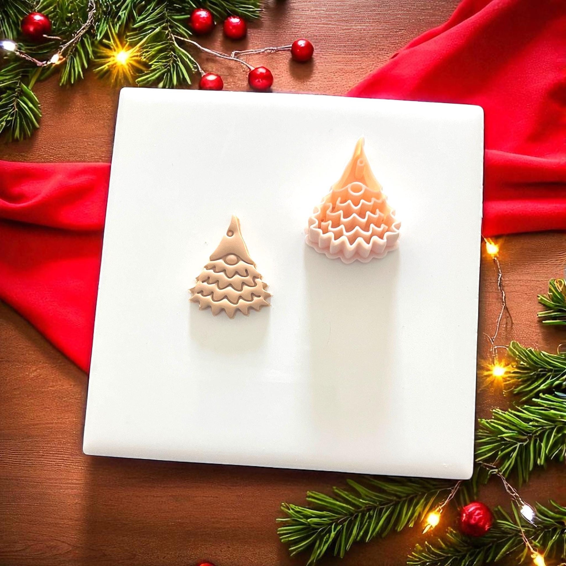 Christmas tree gnome clay cutter and clay impression displayed together on white tile