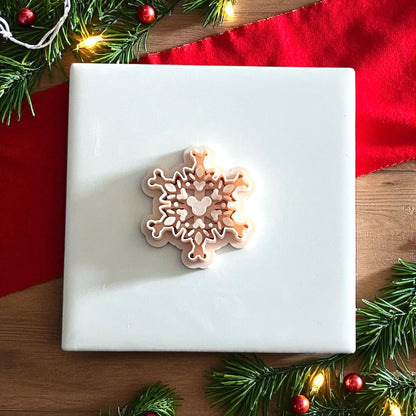 mouse snowflake clay cutter displayed on white tile with red cloth and greenery