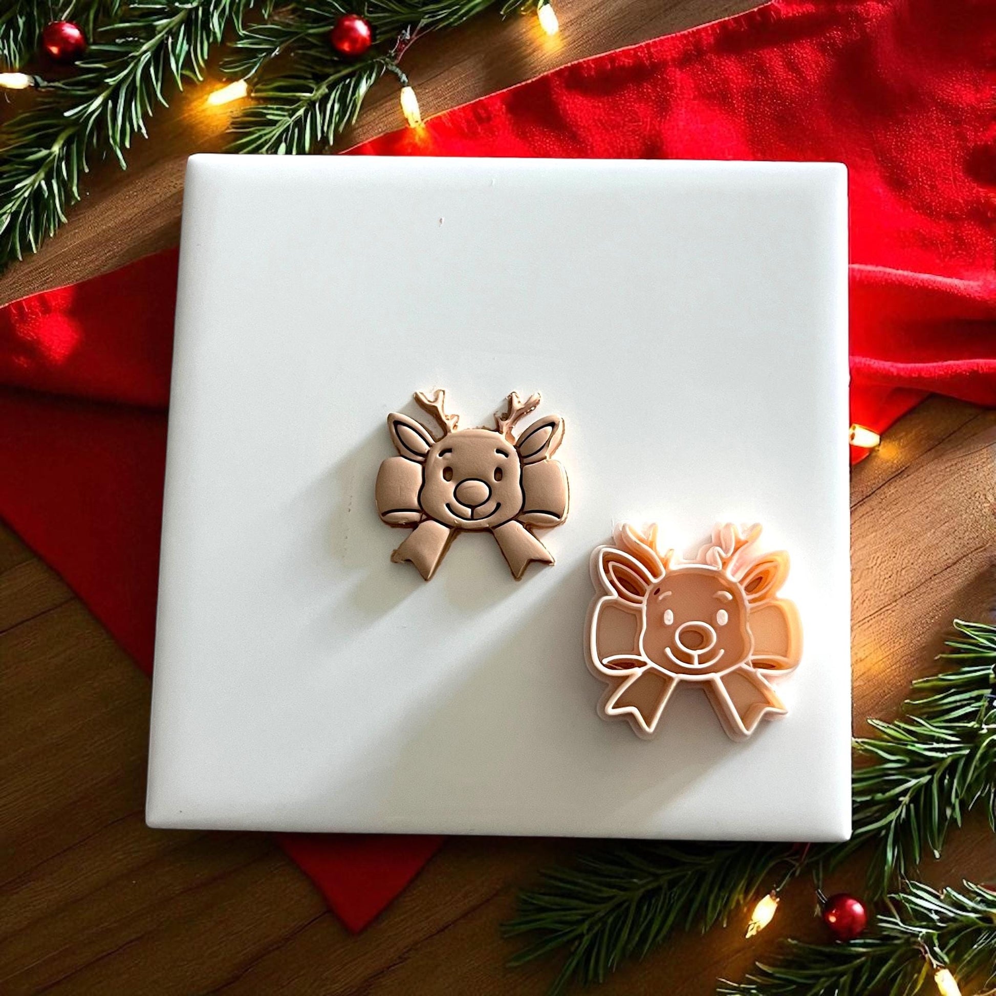 closeup clay impression of reindeer bow design with holiday lights