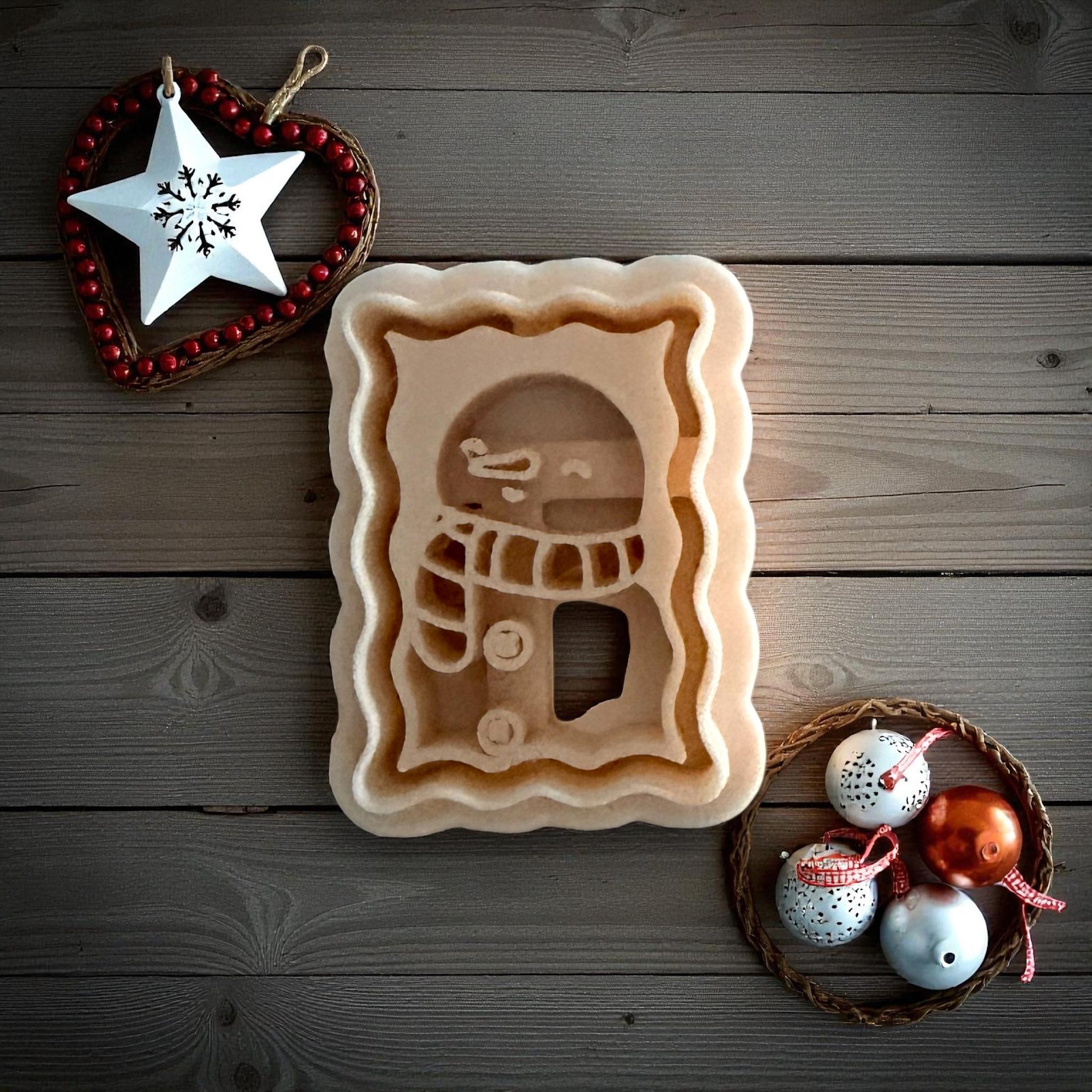 Small snowman postage clay imprint centered on white tile with holiday decor