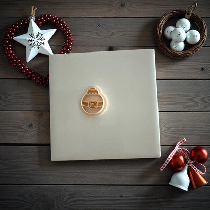 Santa belt ornament clay imprint on wooden background with Christmas ornaments