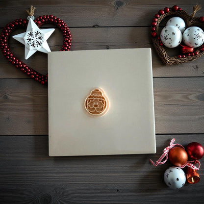 Small Santa ornament clay imprint centered on white tile with festive decor