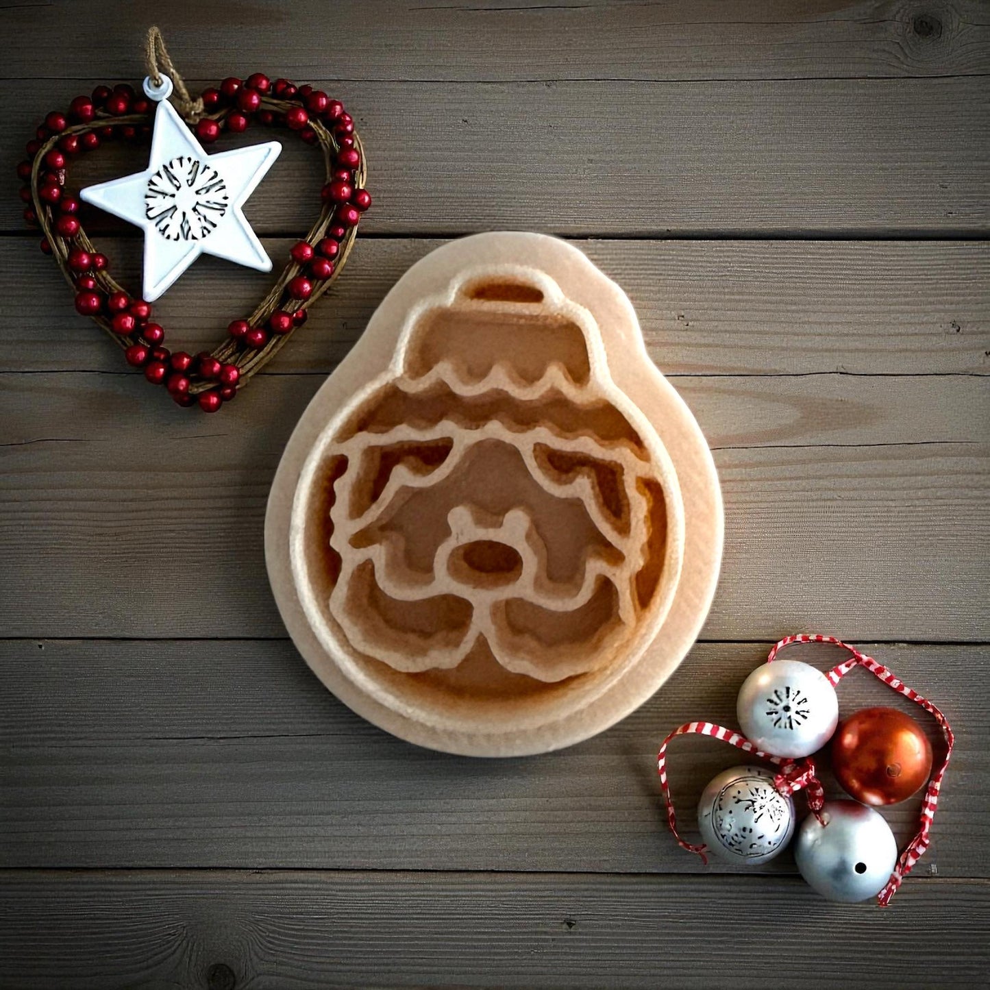 Santa ornament clay imprint on wooden background with Christmas ornaments