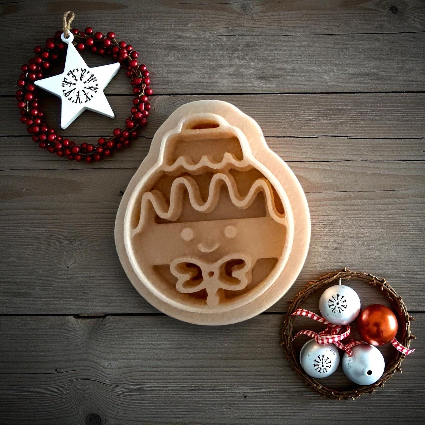Gingerbread ornament clay imprint on wood background with Christmas decor