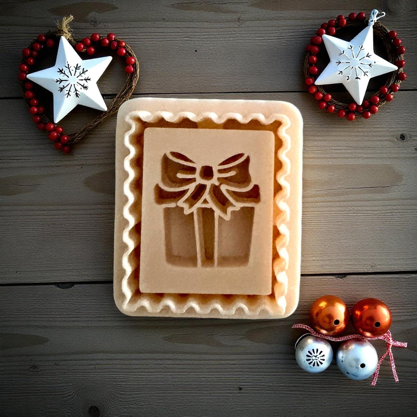 Christmas gift stamp clay imprint on wood background with ornaments and stars