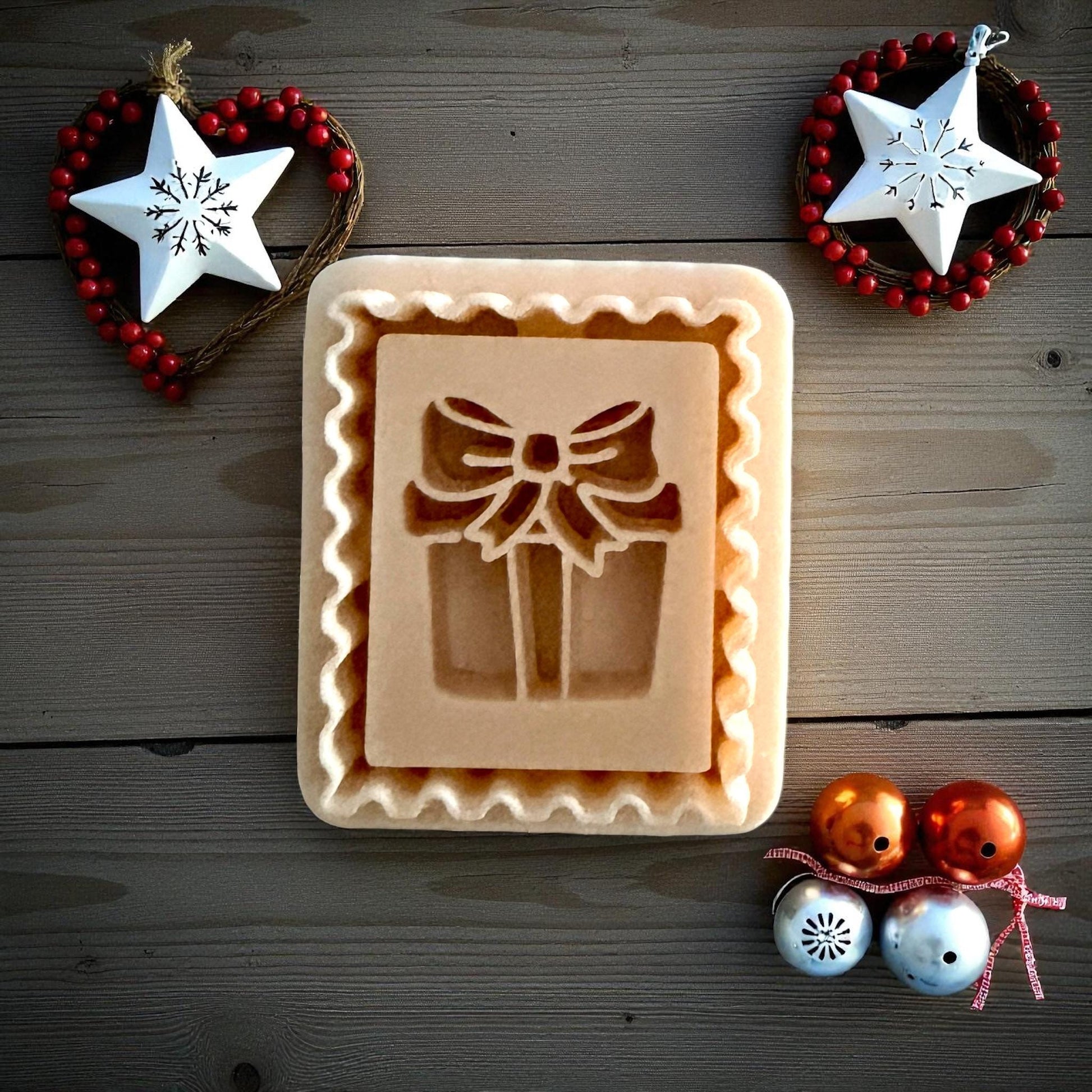 Christmas gift stamp clay imprint on wood background with ornaments and stars
