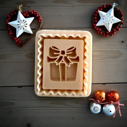 Christmas gift stamp clay imprint on wood background with ornaments and stars