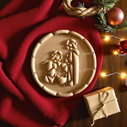 Large nativity clay imprint on red fabric with Christmas lights and wrapped gift