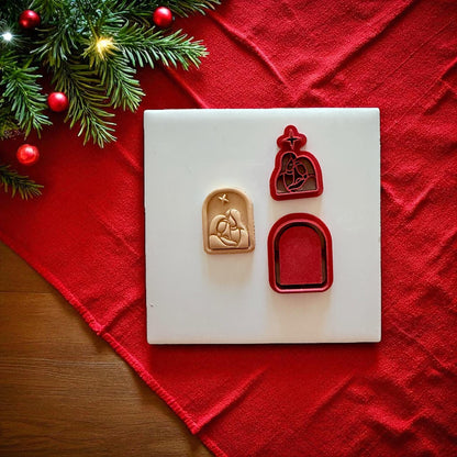 Nativity cutter set and Holy Family clay impression on white tile with red cloth