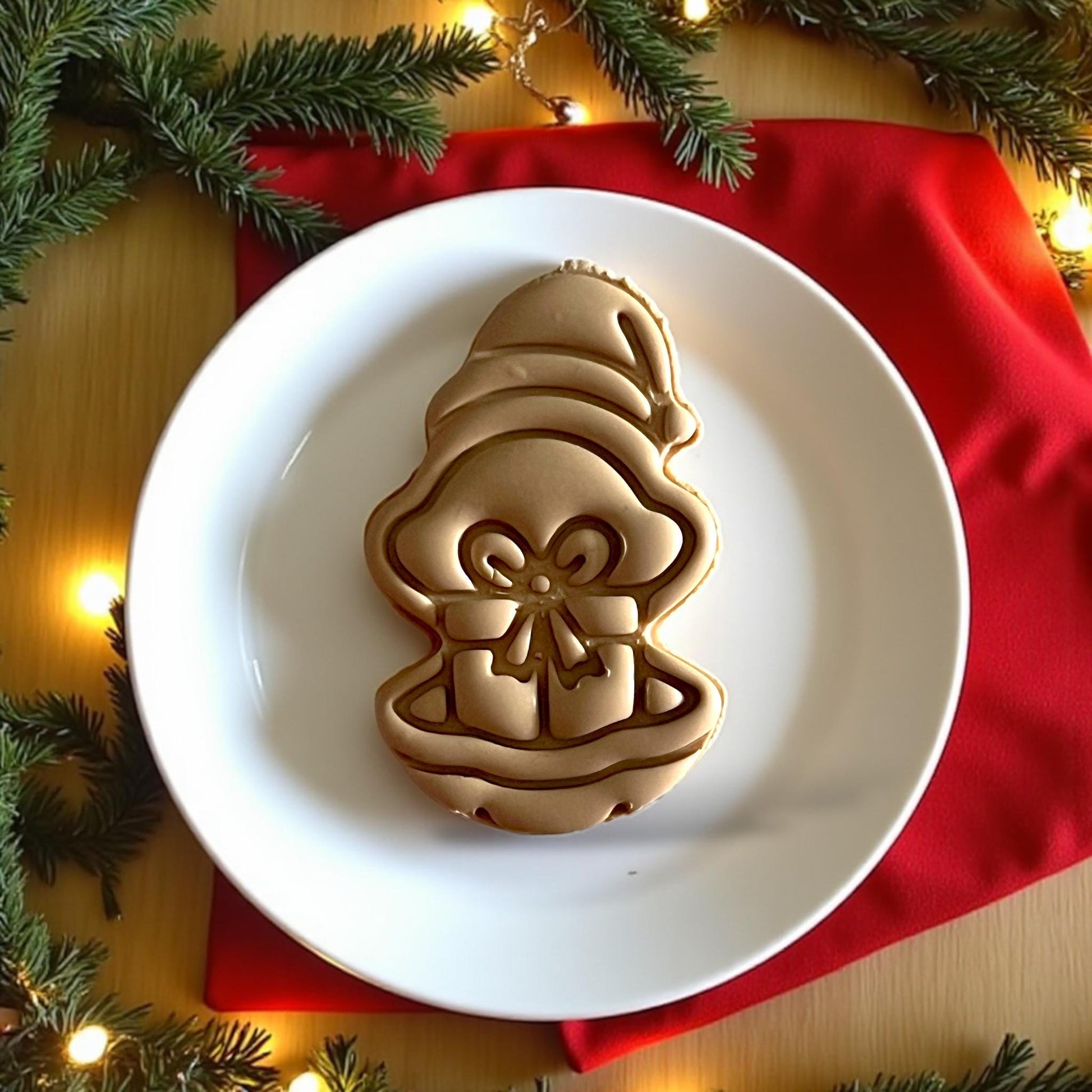 Close-up of finished oyster present clay piece on plate surrounded by Christmas lights
