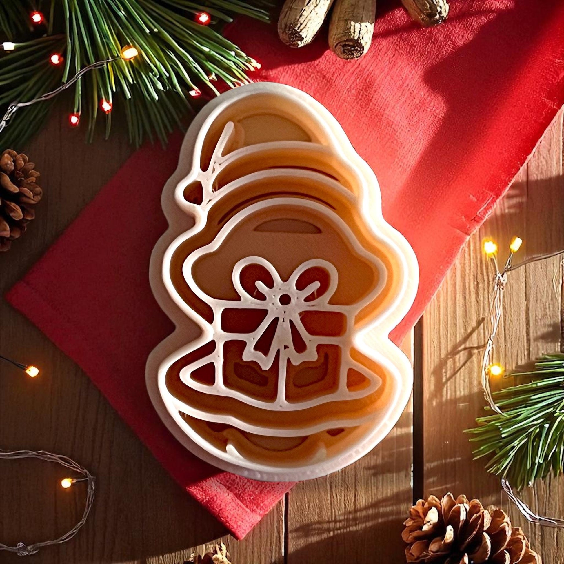 Oyster present polymer clay cutter on wooden surface with red cloth and pine lights