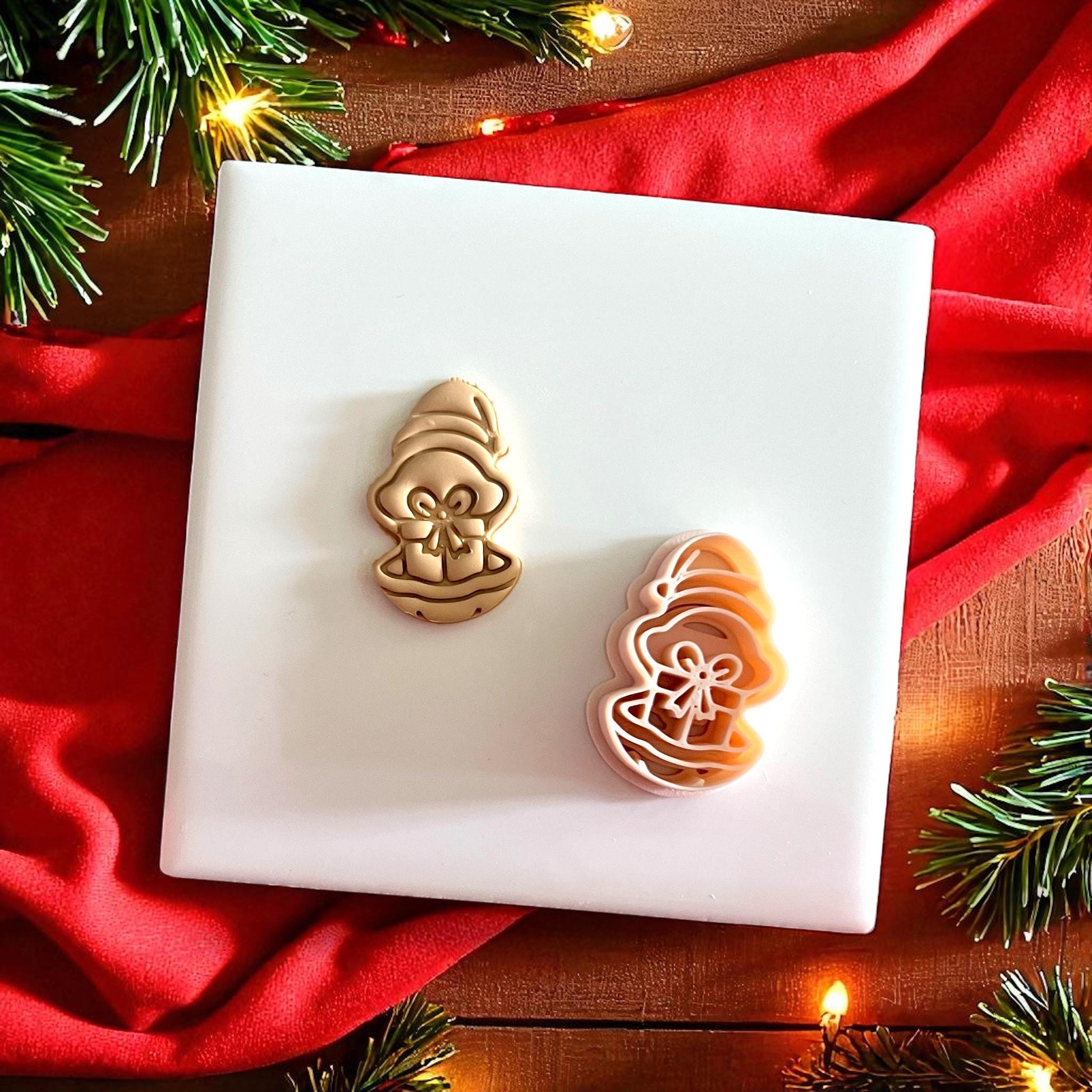 Clay cutter and impression of oyster with present displayed on festive backdrop