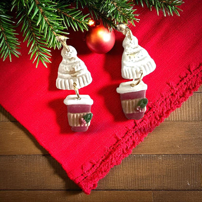 Finished beanie earrings with holiday cup charm shown on red board