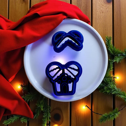 Gingerbread mouse house cutters on white plate with red fabric and Christmas lights