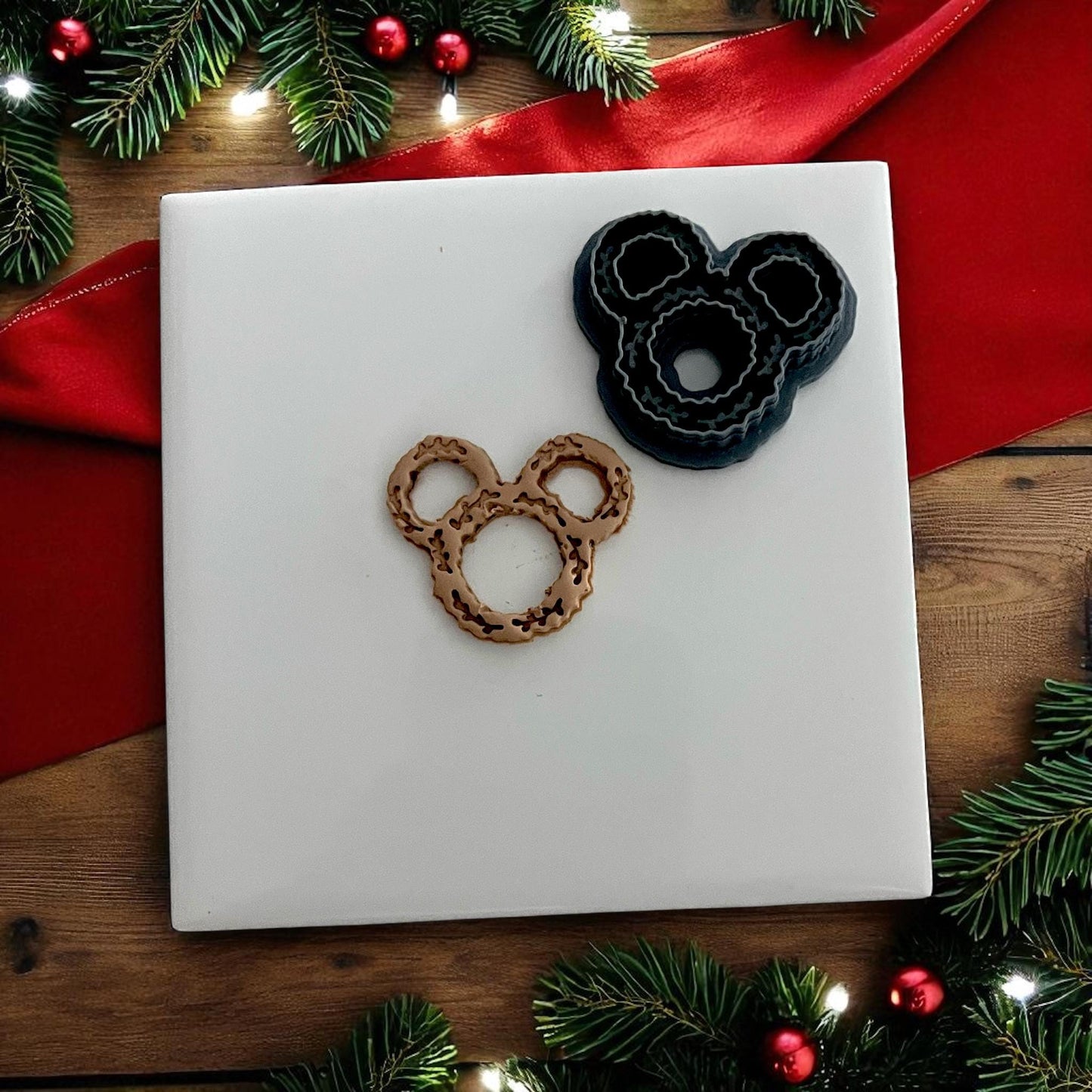 small clay wreath design on white tile surrounded by Christmas décor