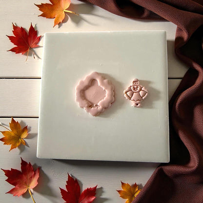 Pilgrim turkey and scalloped clay imprint side by side on white tile with autumn decor