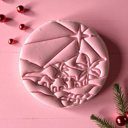 Close-up of pink Bethlehem clay imprint with shining star detail and rooftops