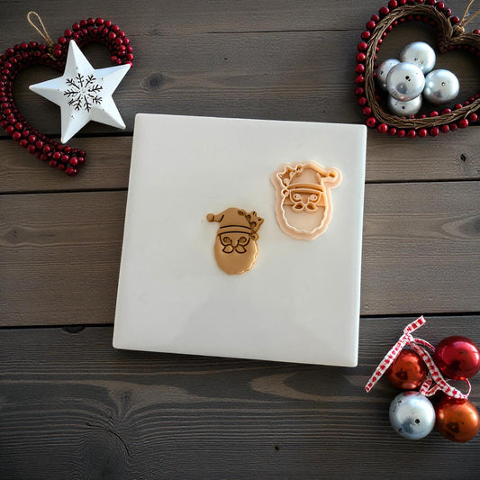 Santa cat polymer clay imprint and cutter displayed on white tile with Christmas ornaments