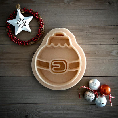 Santa belt ornament clay imprint on wooden background with Christmas ornaments