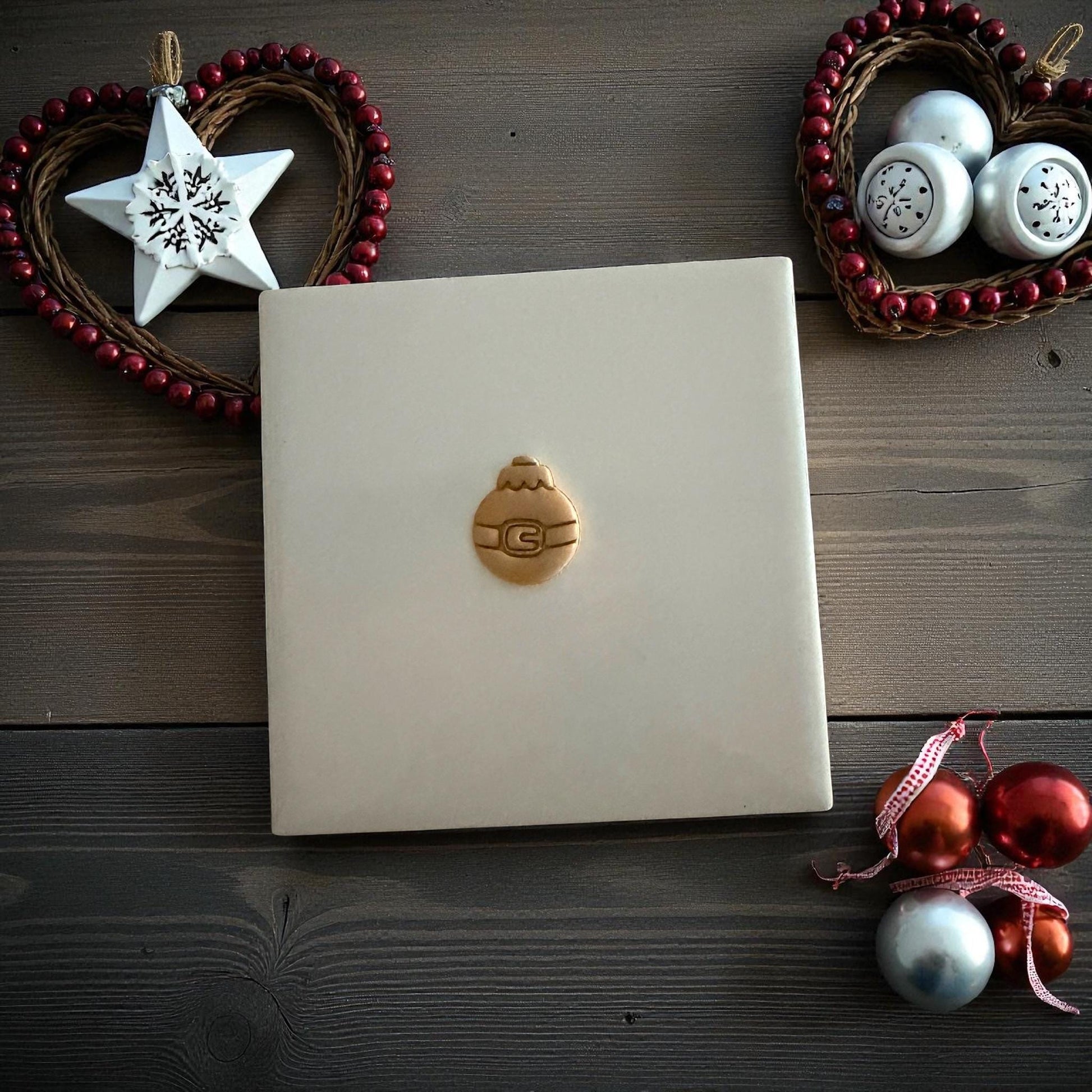 Santa belt ornament clay imprint on wooden background with Christmas ornaments