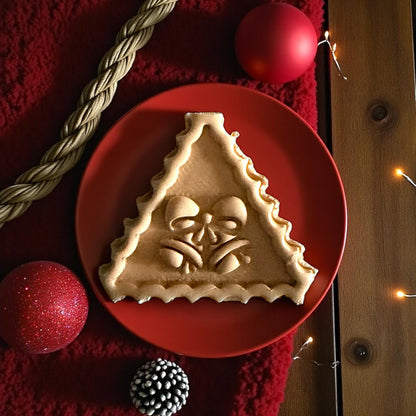 Large jingle bell clay imprint on red plate with Christmas lights and ornaments