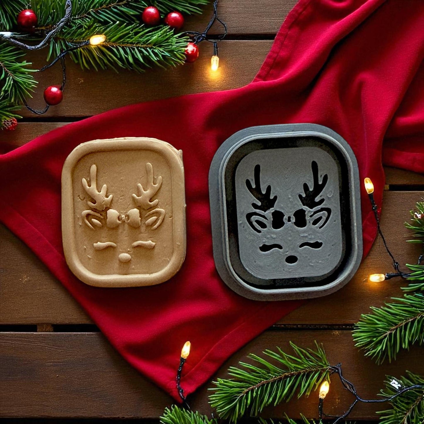 Reindeer cutter and clay piece on red napkin surrounded by string lights