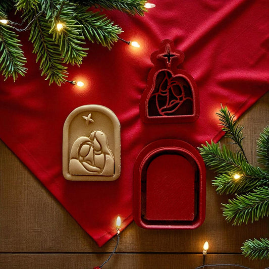 Nativity cutter set and clay piece displayed on red fabric with string lights