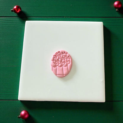 Pink Three Kings clay imprint on white tile with red ornaments