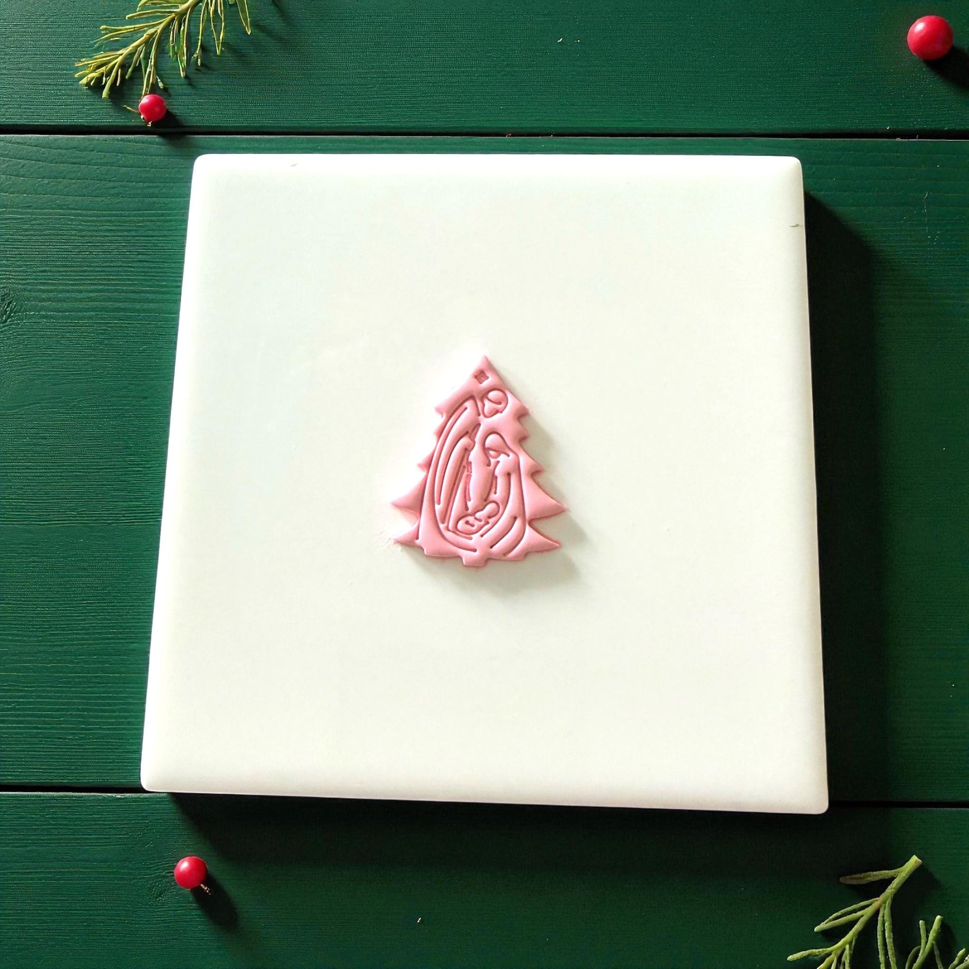 Small pink nativity tree clay imprint centered on white tile